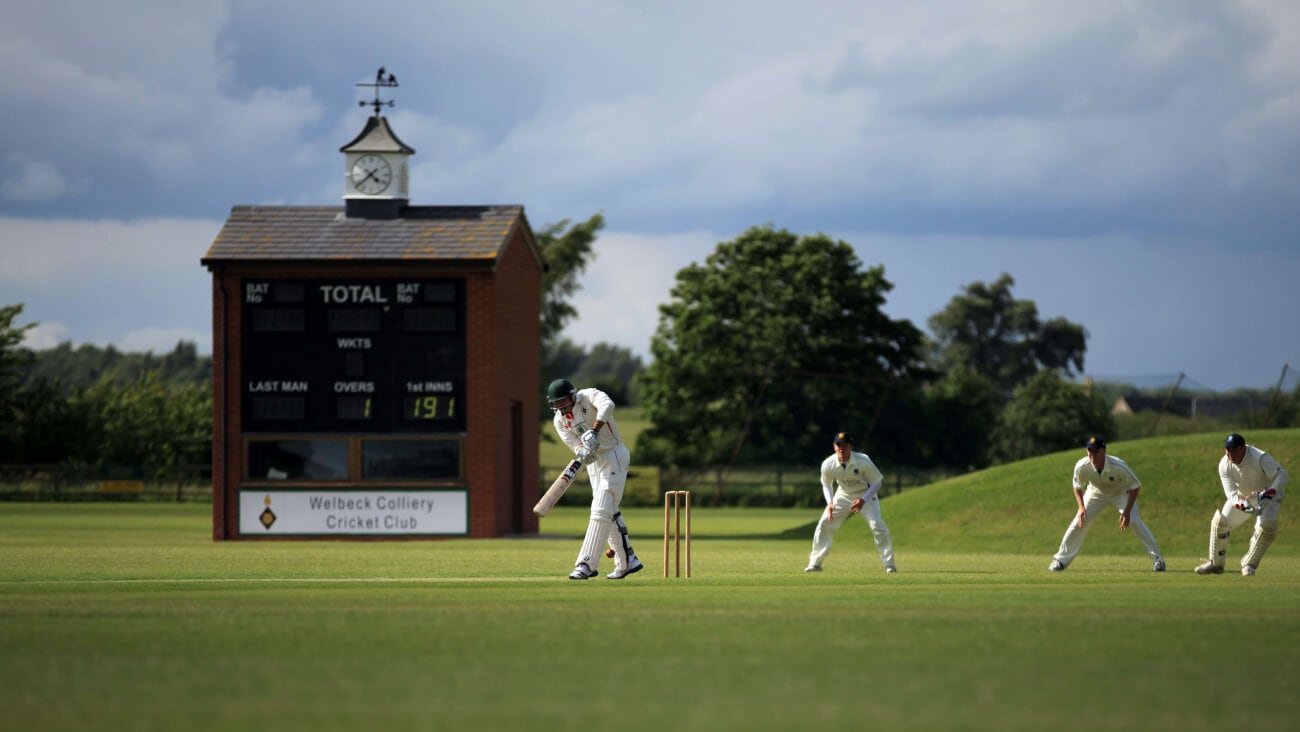 Cricketers playing a game of cricket